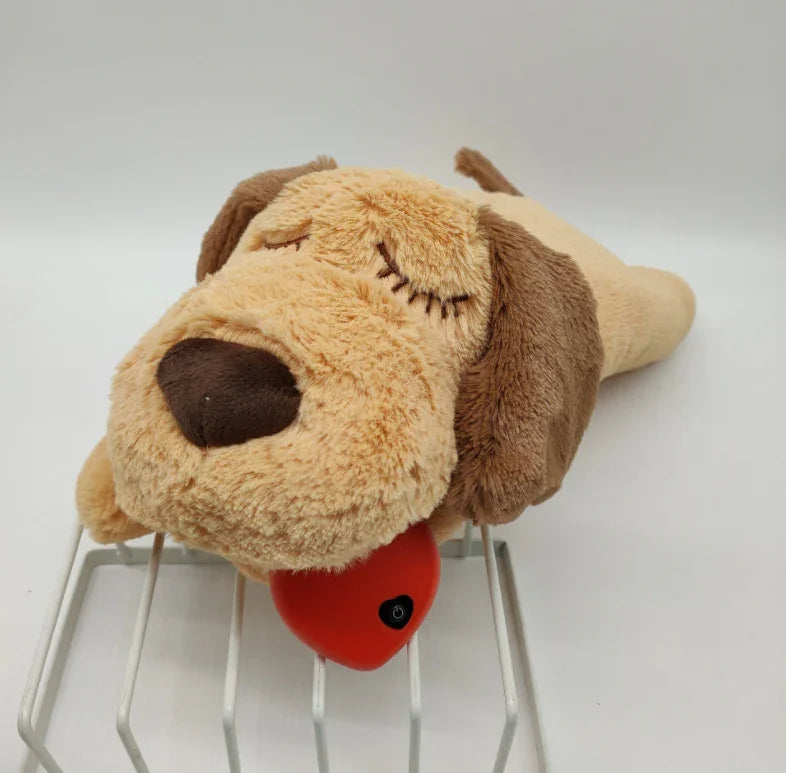 Plush dog toy with brown ears and a red heart-shaped device, set on a white rack