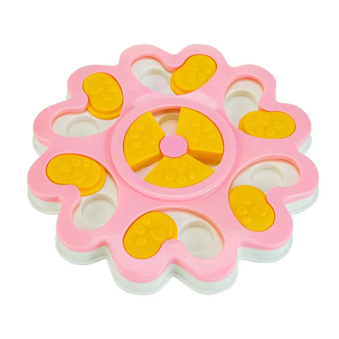 Pink and yellow pet puzzle toy with paw-shaped sliders and circular design