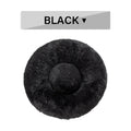 Round black fluffy pet bed with soft plush texture, top view