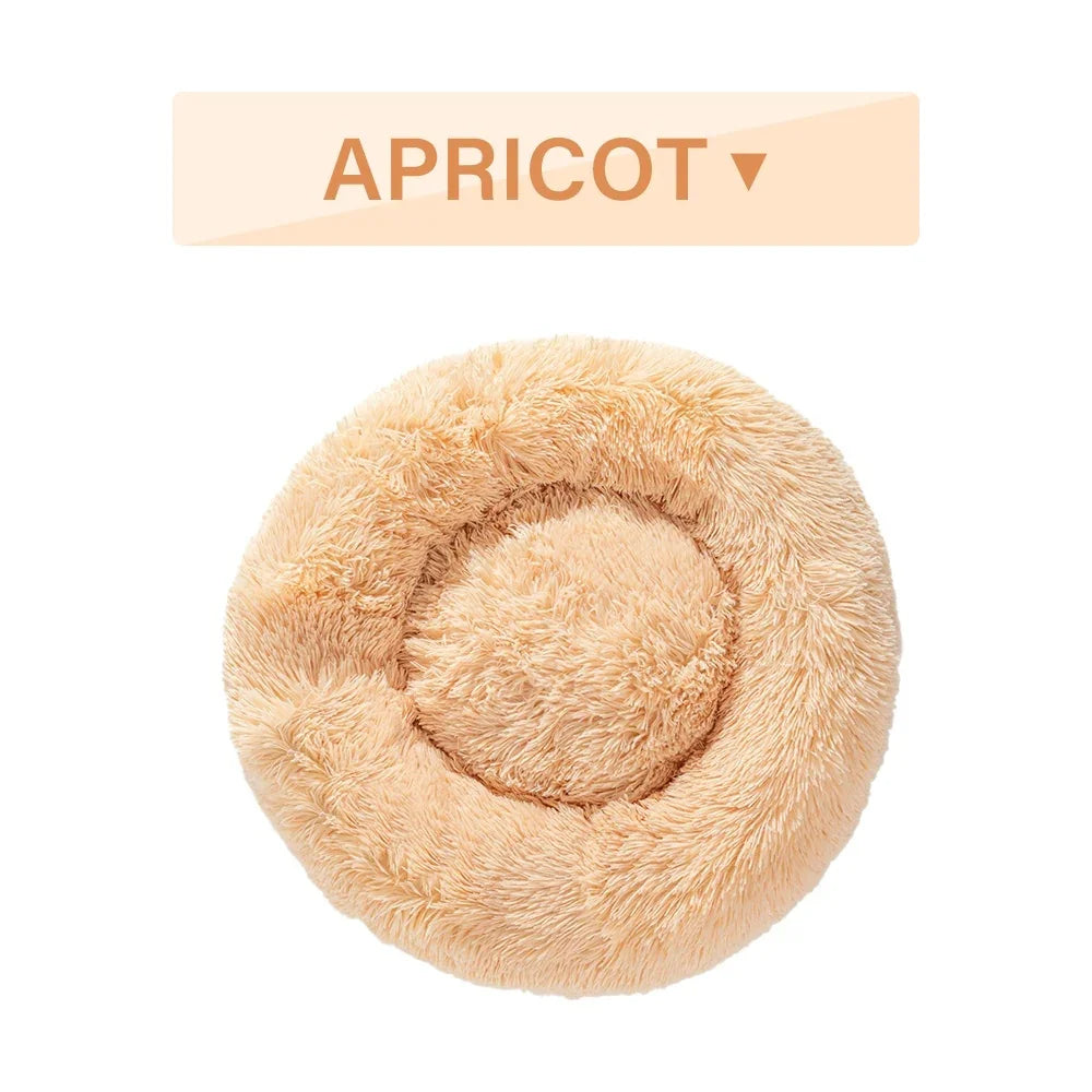Apricot round fluffy pet bed with plush texture on white background