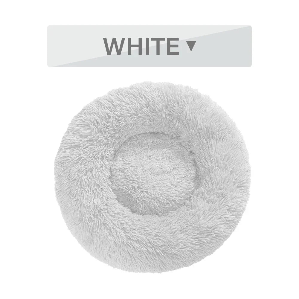 Round fluffy white pet bed with raised rim, shown on a plain background