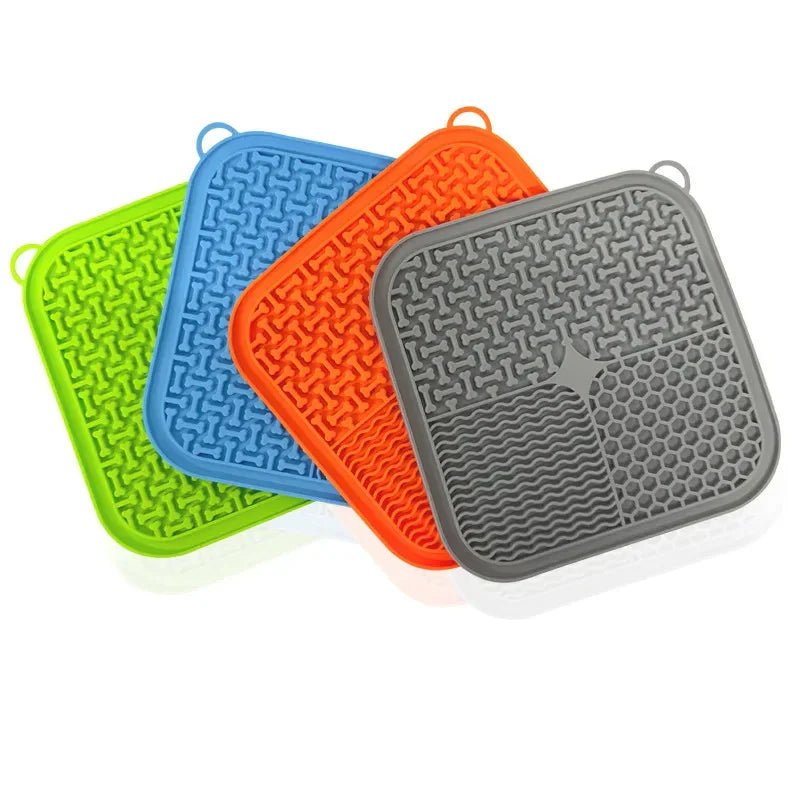 Colorful silicone lick mats with textured surfaces for pets, arranged in a fanned stack.
