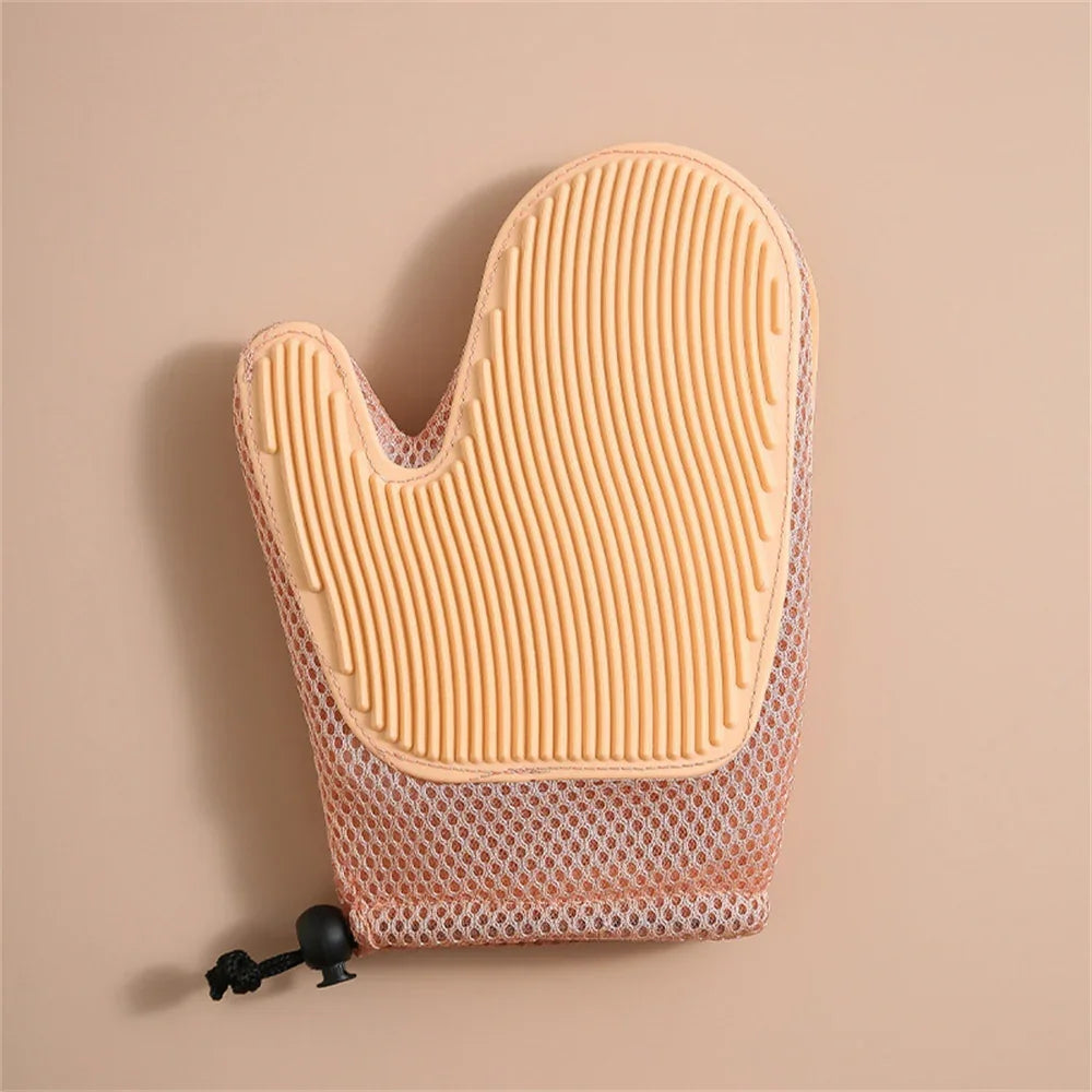 Textured silicone pet grooming glove with mesh wrist on beige background