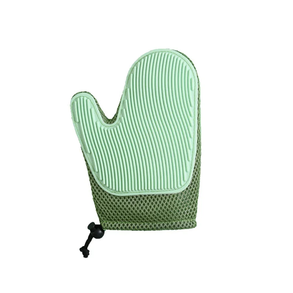 Green silicone pet grooming glove with textured surface and mesh wrist strap on white background
