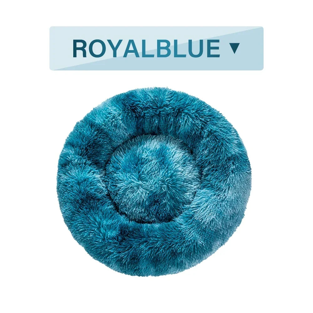 Round fluffy royal blue pet bed on white background