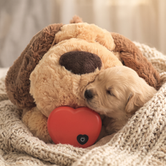 Puppy snuggled into the Heartbeat Plush